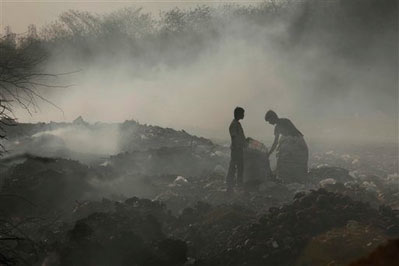 Description: People collect scraps from a garbage dump in Hyderabad, India