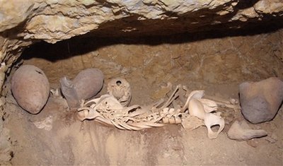 In this undated photo released by the Egyptian Supreme Council of Antiquities on Sunday, Jan. 10, 2010, pottery and bones are seen in a tomb, in Giza, Egypt. Egyptian archaeologists have discovered a new set of tombs of the workers who built the great pyramids, shedding new light on how the laborers lived and ate more than 4,000 years ago, the antiquities department said Sunday. Zahi Hawass, the director of Egypt's Supreme Council of Antiquities, says the tombs are significant because they show that the pyramids were not built by slaves, but rather free workers.